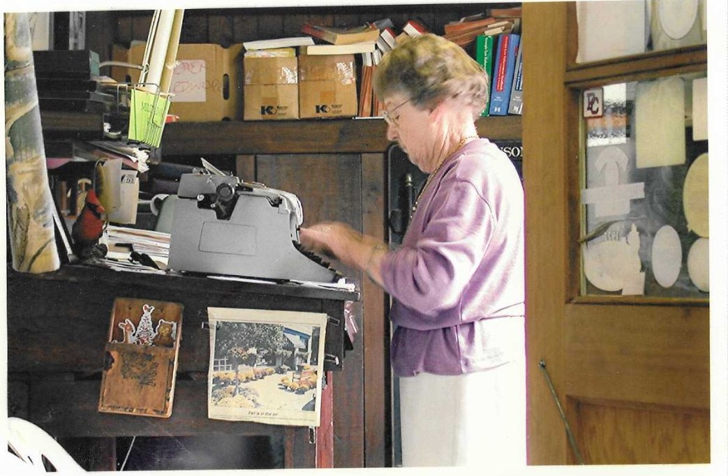 Mildred Ann Palmer typing at a manual typewriter in the store